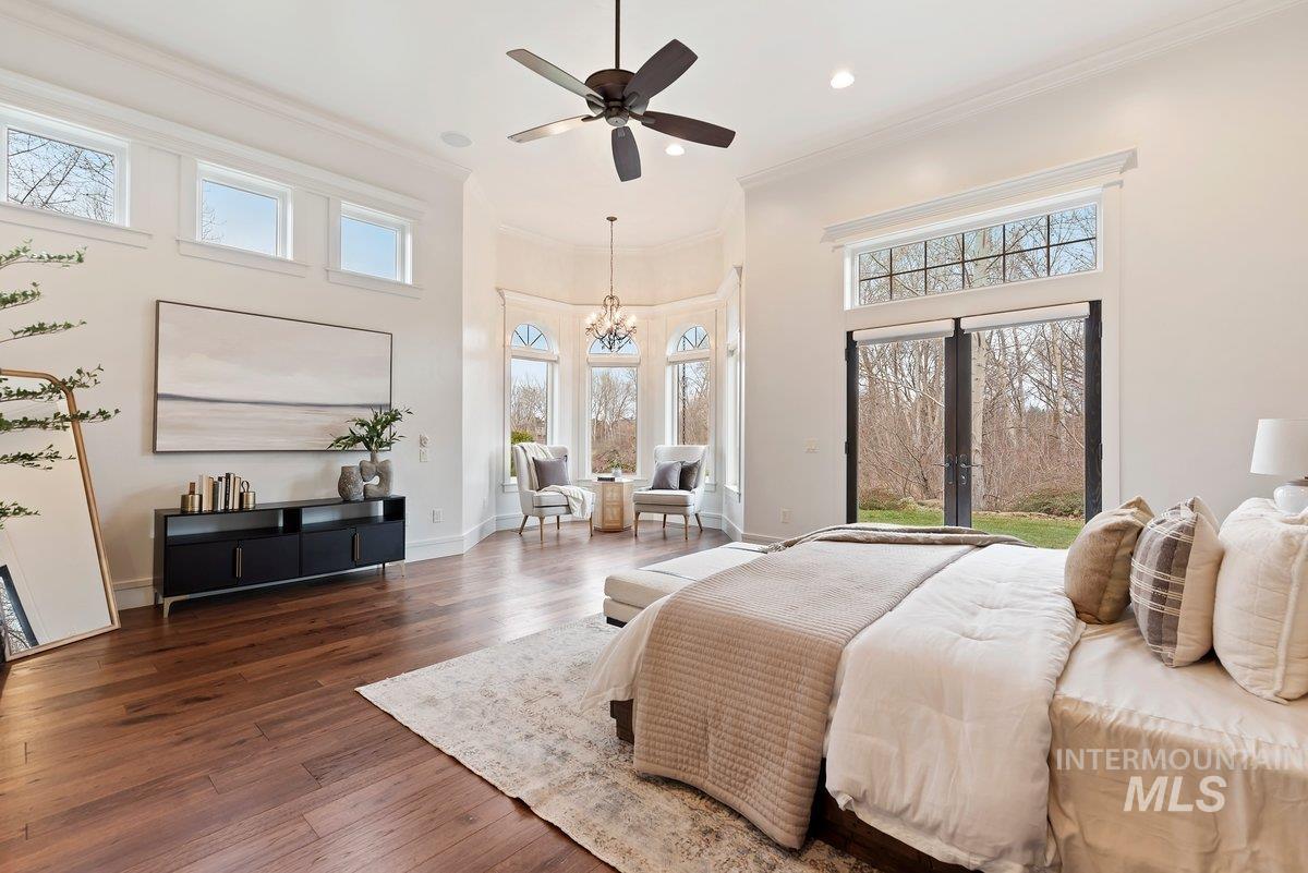 448 East Riversedge Lane Eagle, ID 83616 - Photo 18 of 50 Bedroom with hardwood / wood-style flooring, ornamental molding, a high ceiling, a chandelier, and ceiling fan