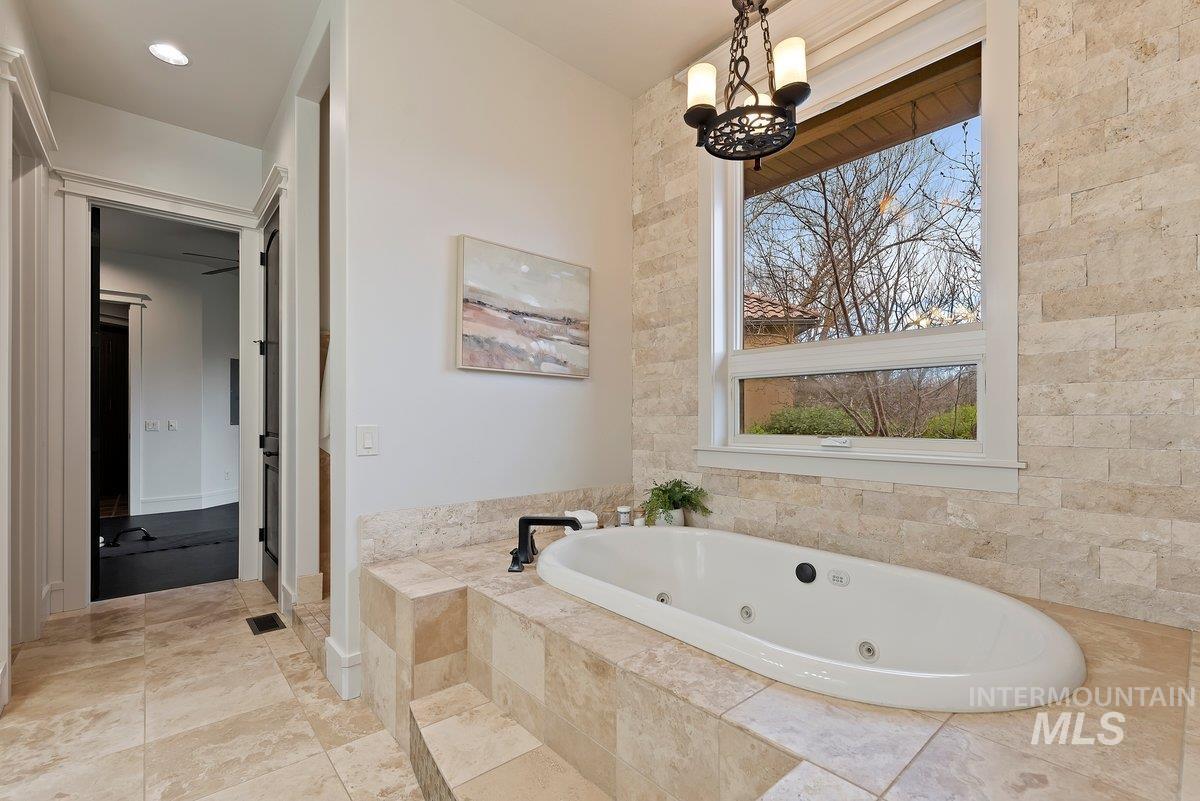 448 East Riversedge Lane Eagle, ID 83616 - Photo 20 of 50 Bathroom featuring a whirlpool tub and a chandelier