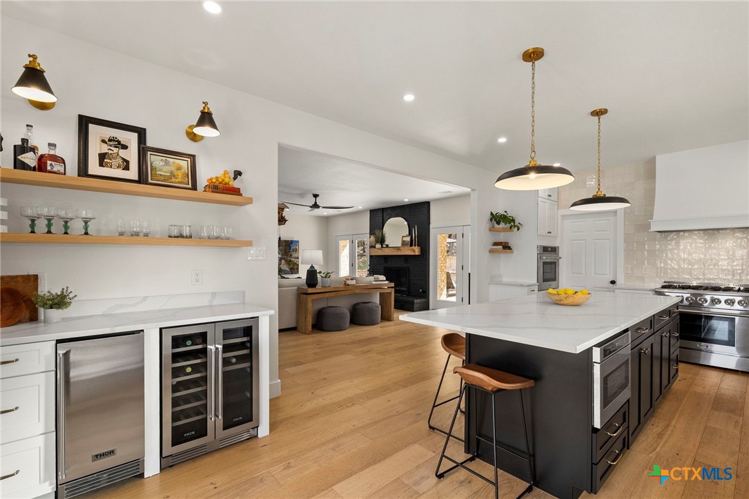 1130 Stoney Ridge Road Bulverde, TX 78163 - Photo 11 of 42 a kitchen with a stove a refrigerator and a stove