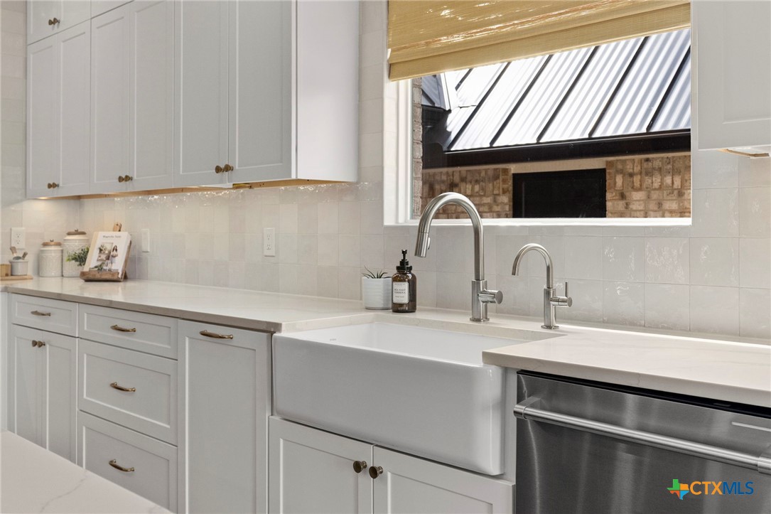 1130 Stoney Ridge Road Bulverde, TX 78163 - Photo 13 of 42 a kitchen with a sink cabinets and a window