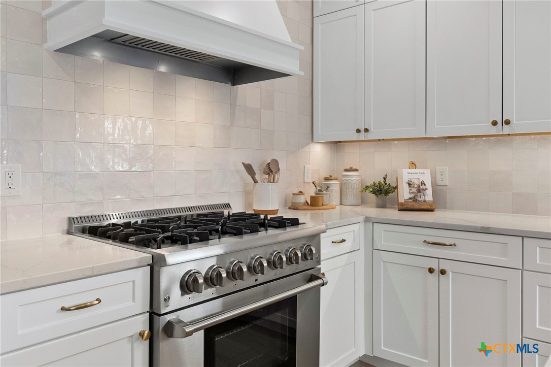 1130 Stoney Ridge Road Bulverde, TX 78163 - Photo 14 of 42 a white stove top oven sitting inside of a kitchen