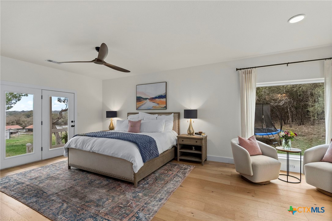 1130 Stoney Ridge Road Bulverde, TX 78163 - Photo 21 of 42 a spacious bedroom with a bed and glass walk in closet