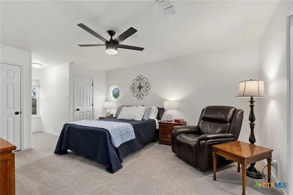 a bedroom with a bed and couch