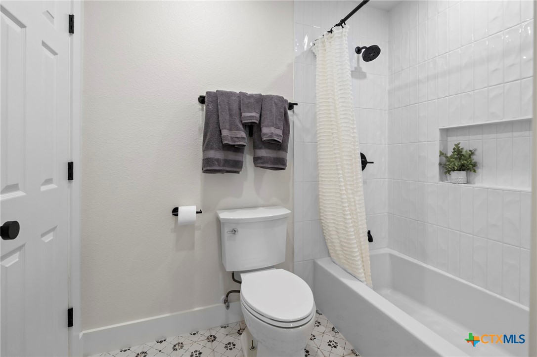 1130 Stoney Ridge Road Bulverde, TX 78163 - Photo 31 of 42 a bathroom with a toilet and a shower