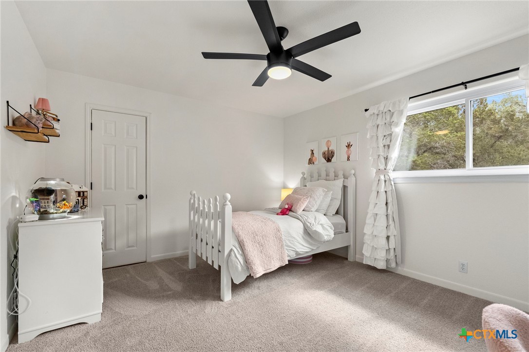 1130 Stoney Ridge Road Bulverde, TX 78163 - Photo 32 of 42 a bedroom with a bed and a window