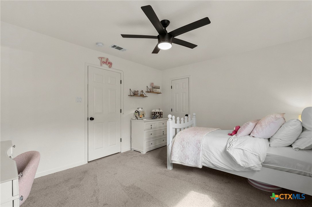 1130 Stoney Ridge Road Bulverde, TX 78163 - Photo 33 of 42 a bedroom with a bed and a ceiling fan