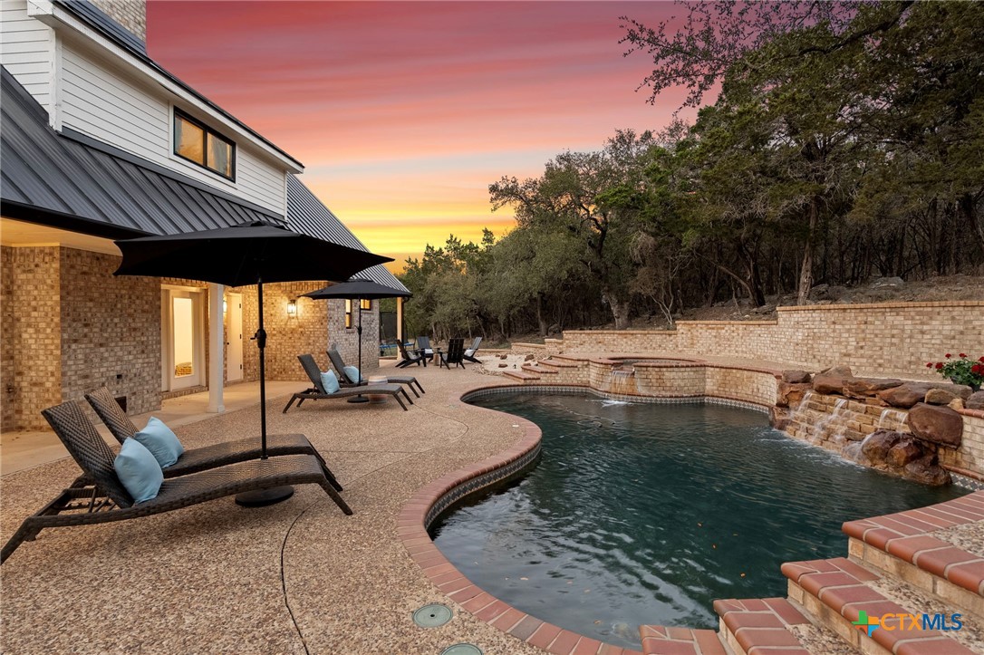 1130 Stoney Ridge Road Bulverde, TX 78163 - Photo 35 of 42 a view of a swimming pool with a patio