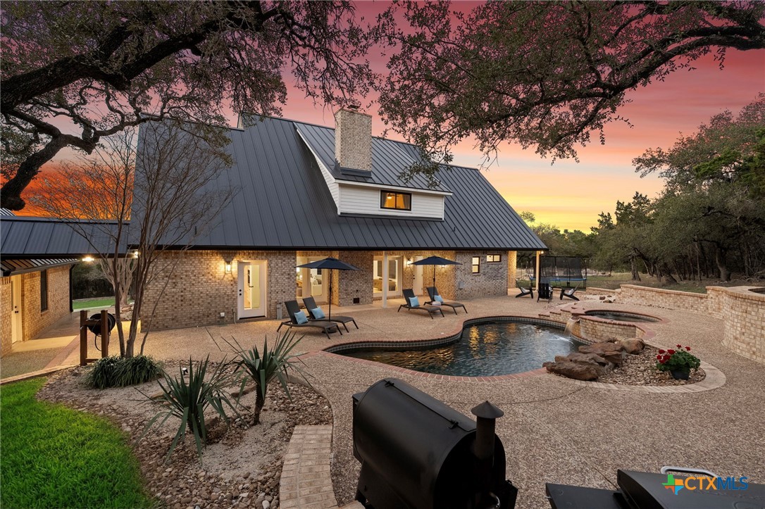 1130 Stoney Ridge Road Bulverde, TX 78163 - Photo 36 of 42 a view of a house with pool and sitting area