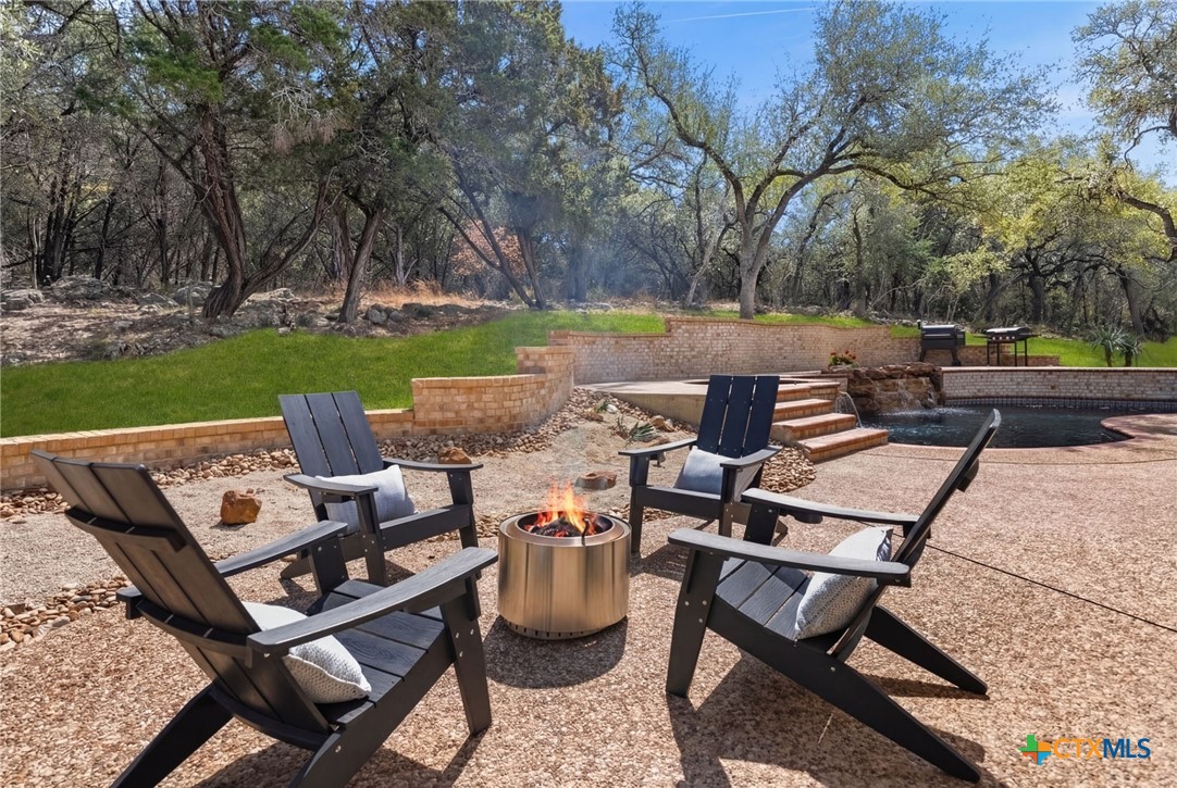 1130 Stoney Ridge Road Bulverde, TX 78163 - Photo 37 of 42 a view of a patio with chairs and a table