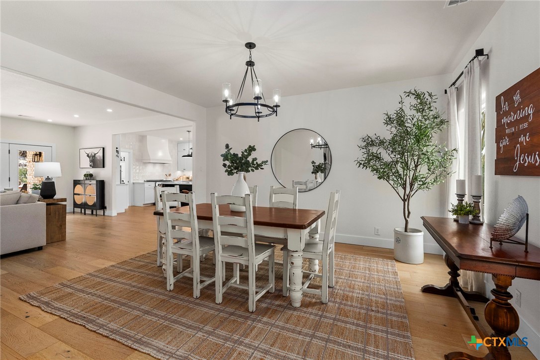 1130 Stoney Ridge Road Bulverde, TX 78163 - Photo 5 of 42 a view of a dining room with furniture window and wooden floor