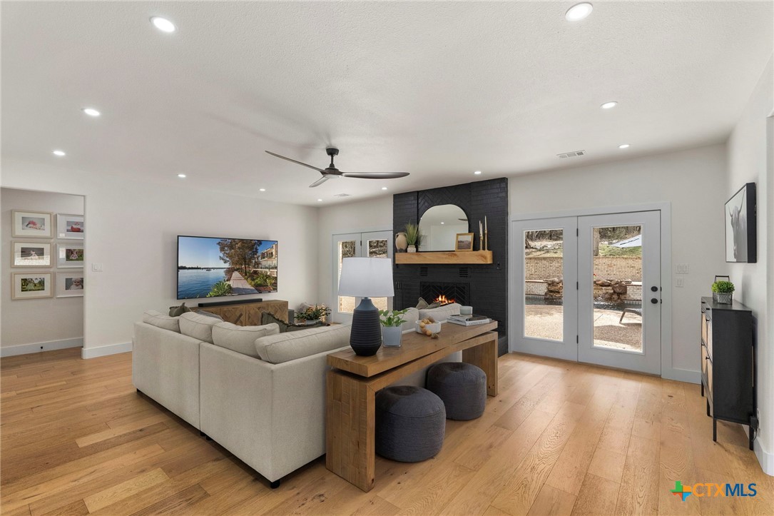 1130 Stoney Ridge Road Bulverde, TX 78163 - Photo 7 of 42 a living room with furniture and a wooden floor