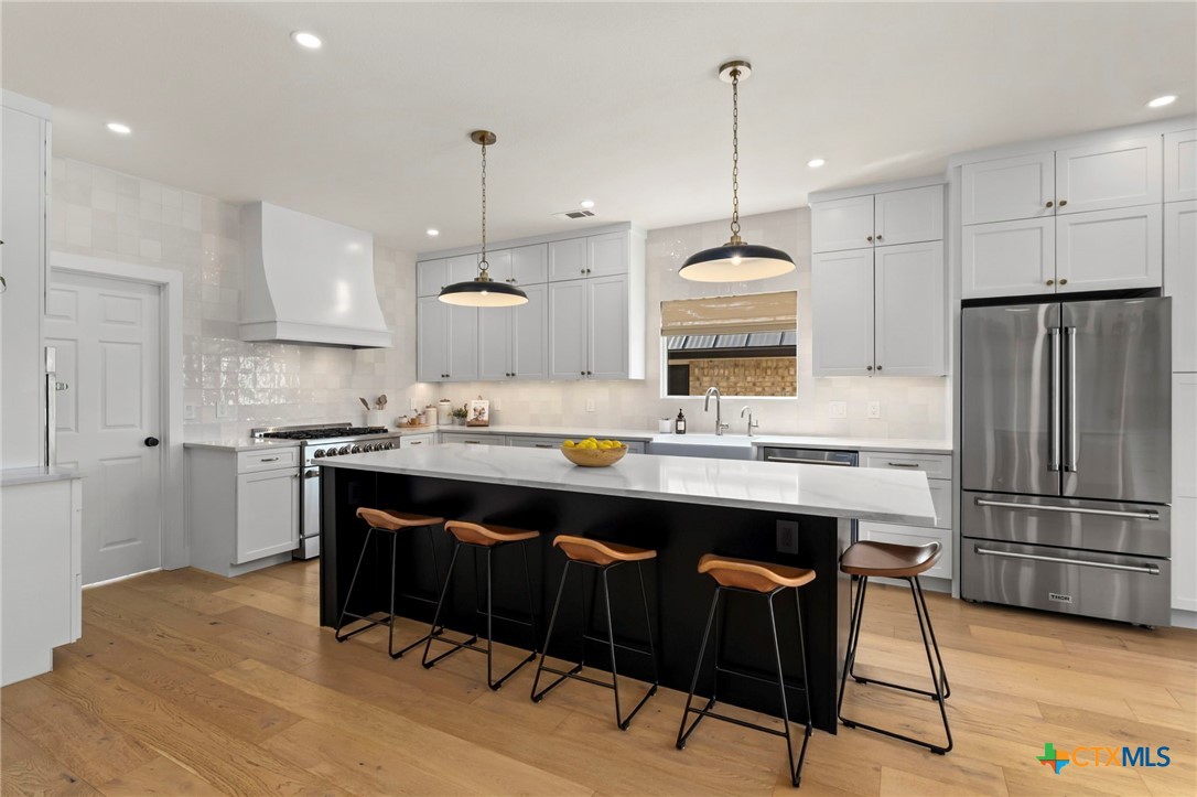 1130 Stoney Ridge Road Bulverde, TX 78163 - Photo 10 of 42 a kitchen with kitchen island granite countertop a sink a center island and stainless steel appliances