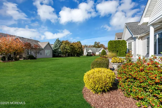 a dining room with furniture a chandelier and window