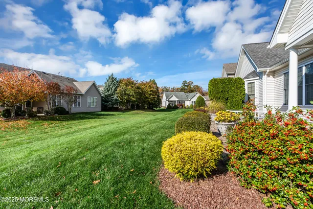 a living room with furniture a fireplace and a large window