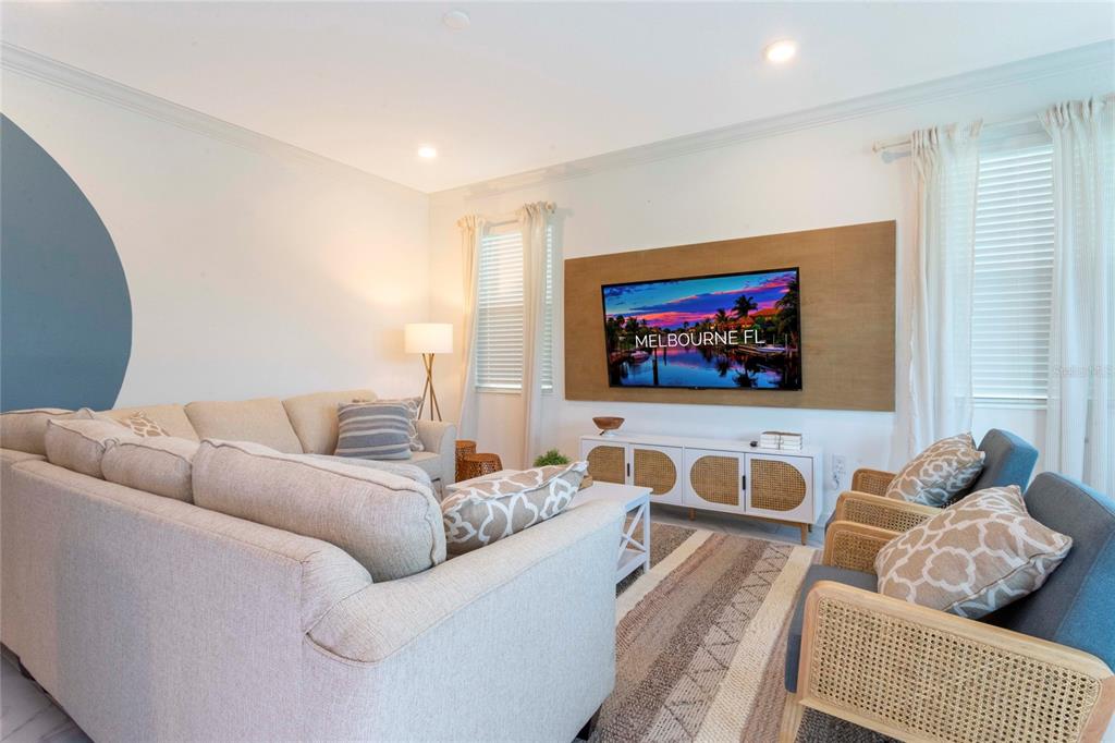 445 Strand Drive Melbourne Beach, FL 32951 - Photo 21 of 99 a living room with furniture and a flat screen tv