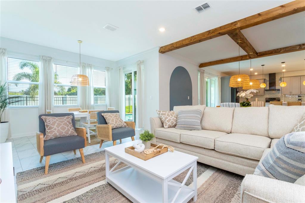 445 Strand Drive Melbourne Beach, FL 32951 - Photo 27 of 99 a living room with furniture and a large window