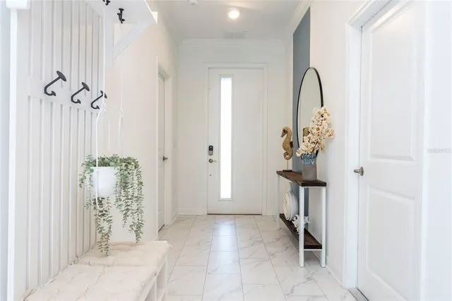 a bathroom with a sink a potted plant and a glass door