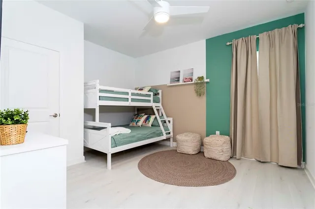 a bedroom with a bed and painting on the wall