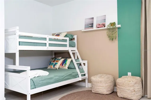 a bedroom with a bed and a painting on the wall