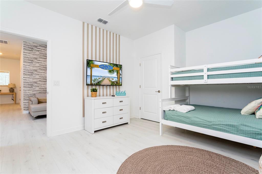 445 Strand Drive Melbourne Beach, FL 32951 - Photo 33 of 99 a bedroom with a bunk bed and a dresser