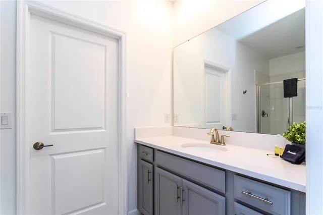 a bedroom with a bed and a view of cabinet