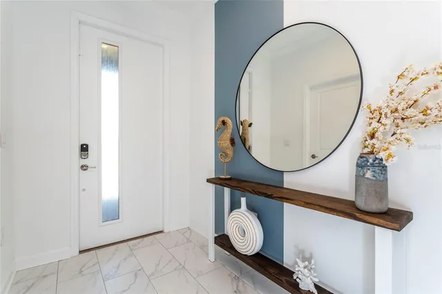 a kitchen with white cabinets and black appliances