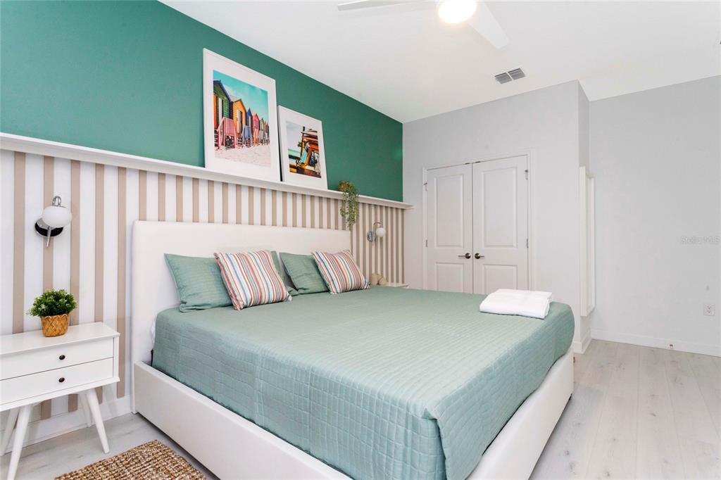 445 Strand Drive Melbourne Beach, FL 32951 - Photo 41 of 99 a bedroom with a bed and a painting on the wall