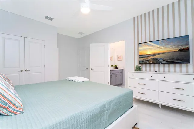 a bedroom with a bed and flat screen tv