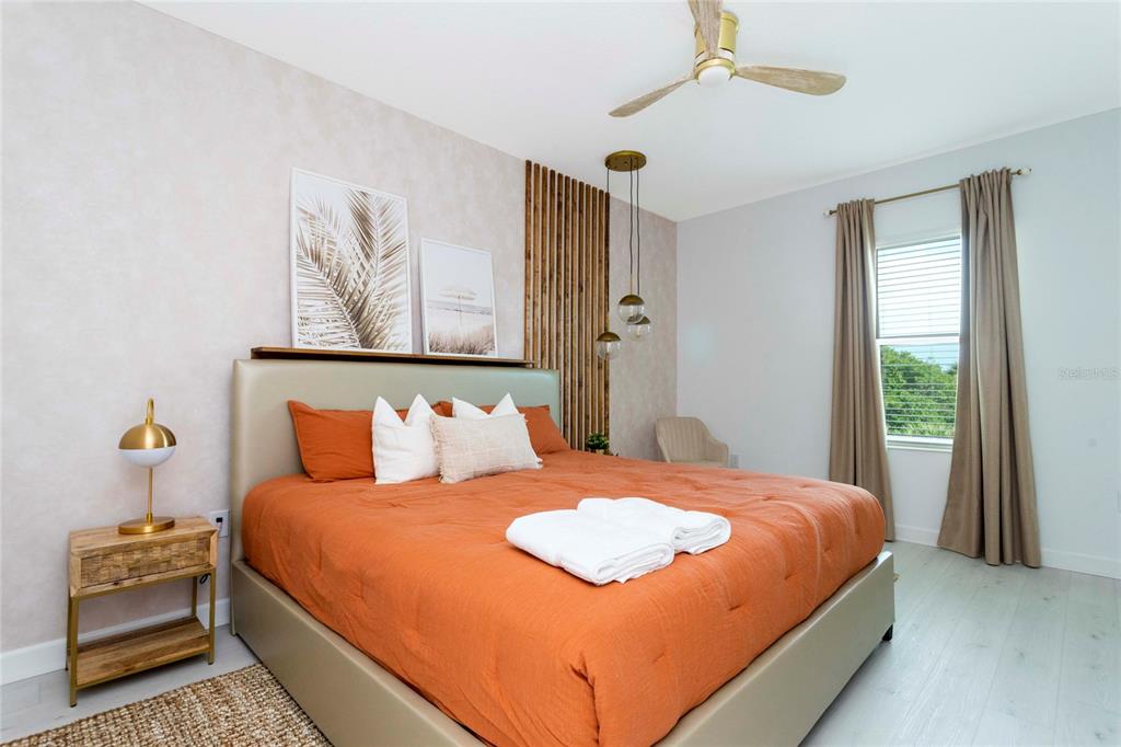 445 Strand Drive Melbourne Beach, FL 32951 - Photo 44 of 99 a bedroom with a bed and wooden floor