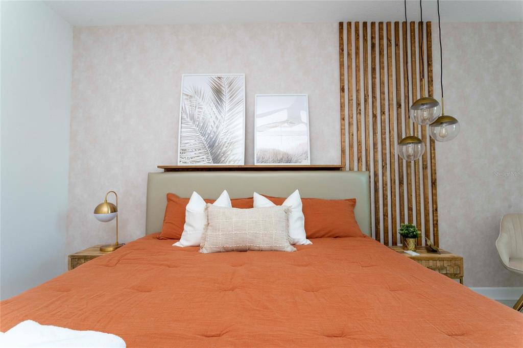 445 Strand Drive Melbourne Beach, FL 32951 - Photo 45 of 99 a bedroom with a bed and painting on the wall