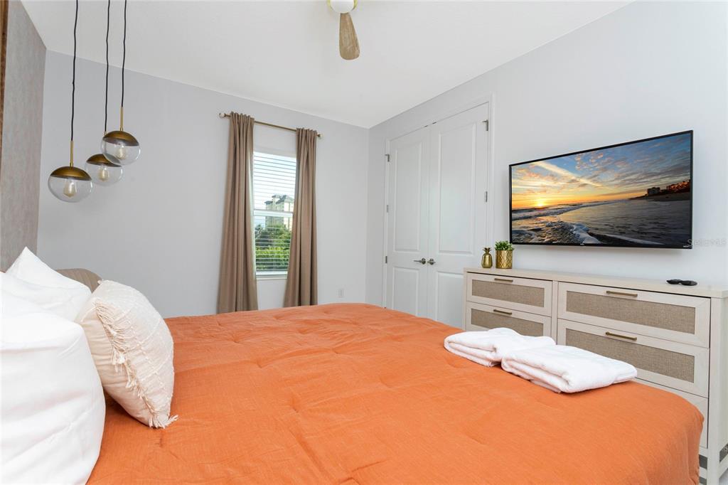 445 Strand Drive Melbourne Beach, FL 32951 - Photo 47 of 99 a bedroom with a bed and a flat screen tv