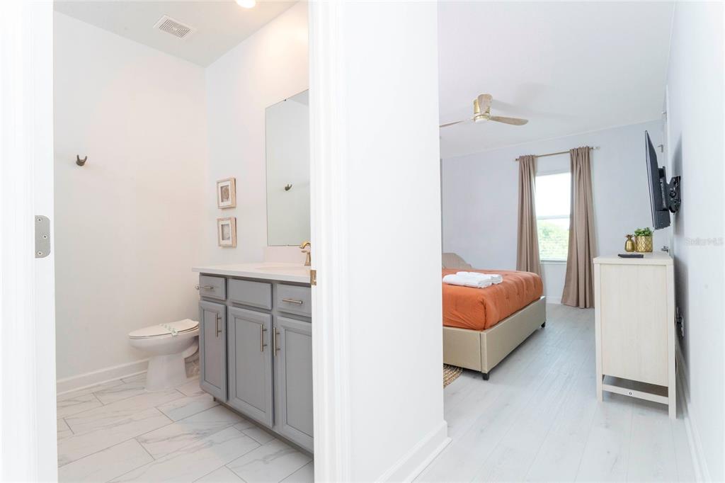 445 Strand Drive Melbourne Beach, FL 32951 - Photo 48 of 99 a bathroom with a white toilet sink and mirror