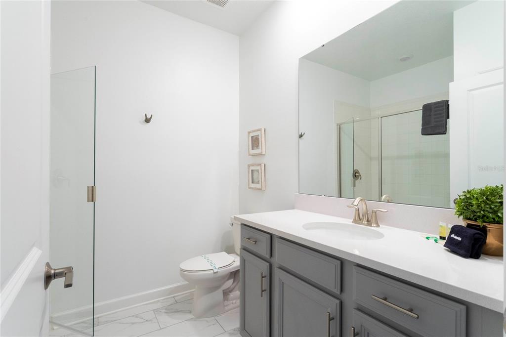 445 Strand Drive Melbourne Beach, FL 32951 - Photo 49 of 99 a bathroom with a sink a toilet and shower