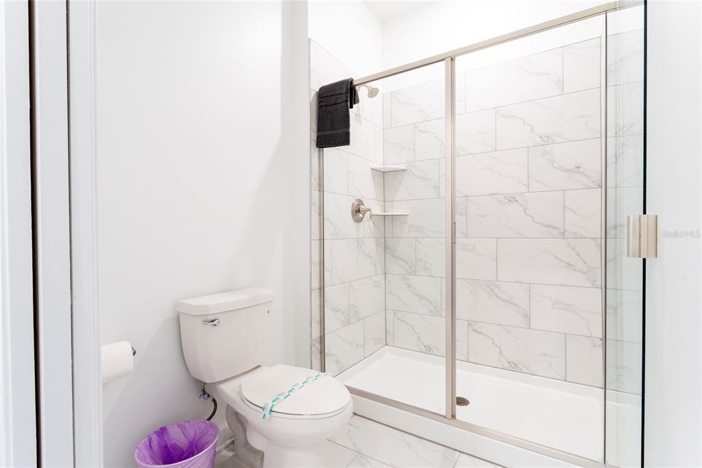 445 Strand Drive Melbourne Beach, FL 32951 - Photo 58 of 99 a bathroom with a toilet and a shower