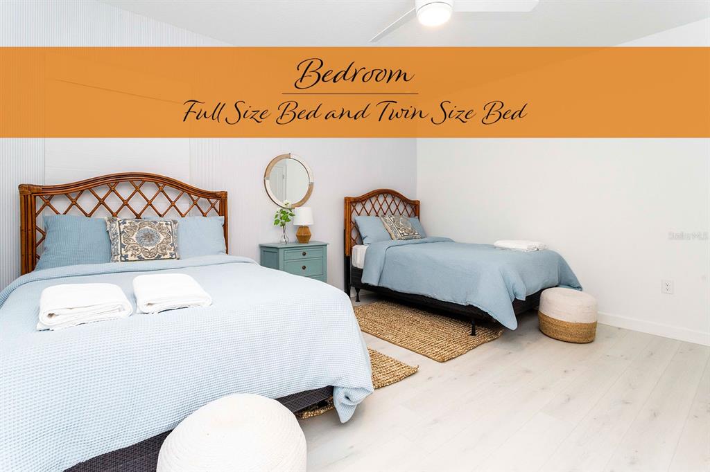 445 Strand Drive Melbourne Beach, FL 32951 - Photo 59 of 99 a bedroom with a bed and wooden floor