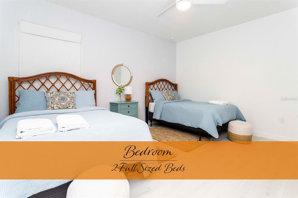 445 Strand Drive Melbourne Beach, FL 32951 - Photo 60 of 99 a bedroom with a bed and wooden floor