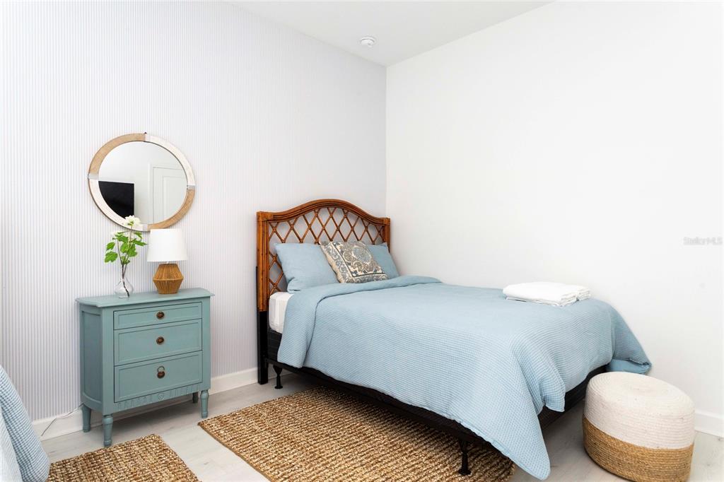 445 Strand Drive Melbourne Beach, FL 32951 - Photo 63 of 99 a bedroom with a bed and a painting on the wall