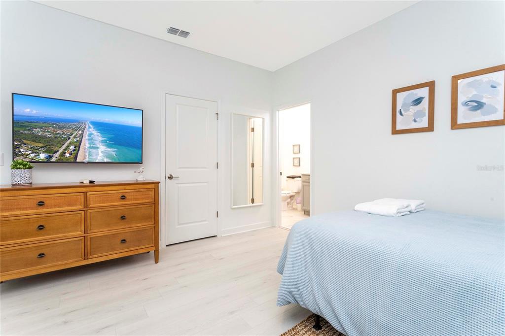 445 Strand Drive Melbourne Beach, FL 32951 - Photo 65 of 99 a bedroom with a bed and a dresser