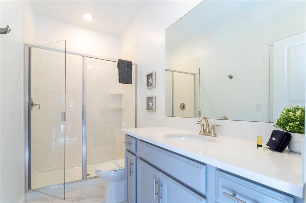 445 Strand Drive Melbourne Beach, FL 32951 - Photo 73 of 99 a bathroom with a sink a toilet and shower