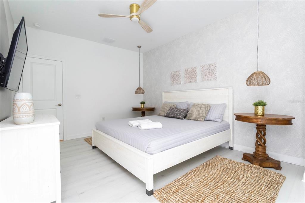 445 Strand Drive Melbourne Beach, FL 32951 - Photo 81 of 99 a bedroom with a bed and a table in it