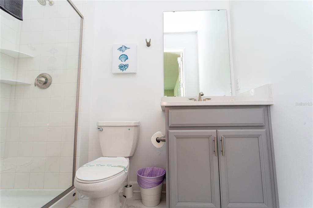 445 Strand Drive Melbourne Beach, FL 32951 - Photo 91 of 99 a bathroom with a sink a toilet and a mirror