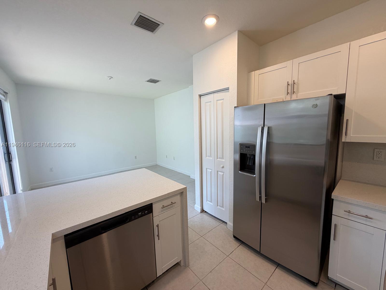 3326 West 112th Street Hialeah, FL 33018 - Photo 11 of 37 a kitchen with stainless steel appliances a refrigerator and a stove