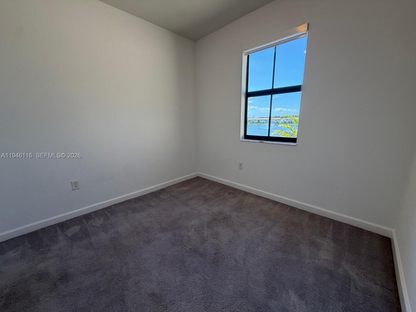 3326 West 112th Street Hialeah, FL 33018 - Photo 13 of 37 an empty room with windows and closet