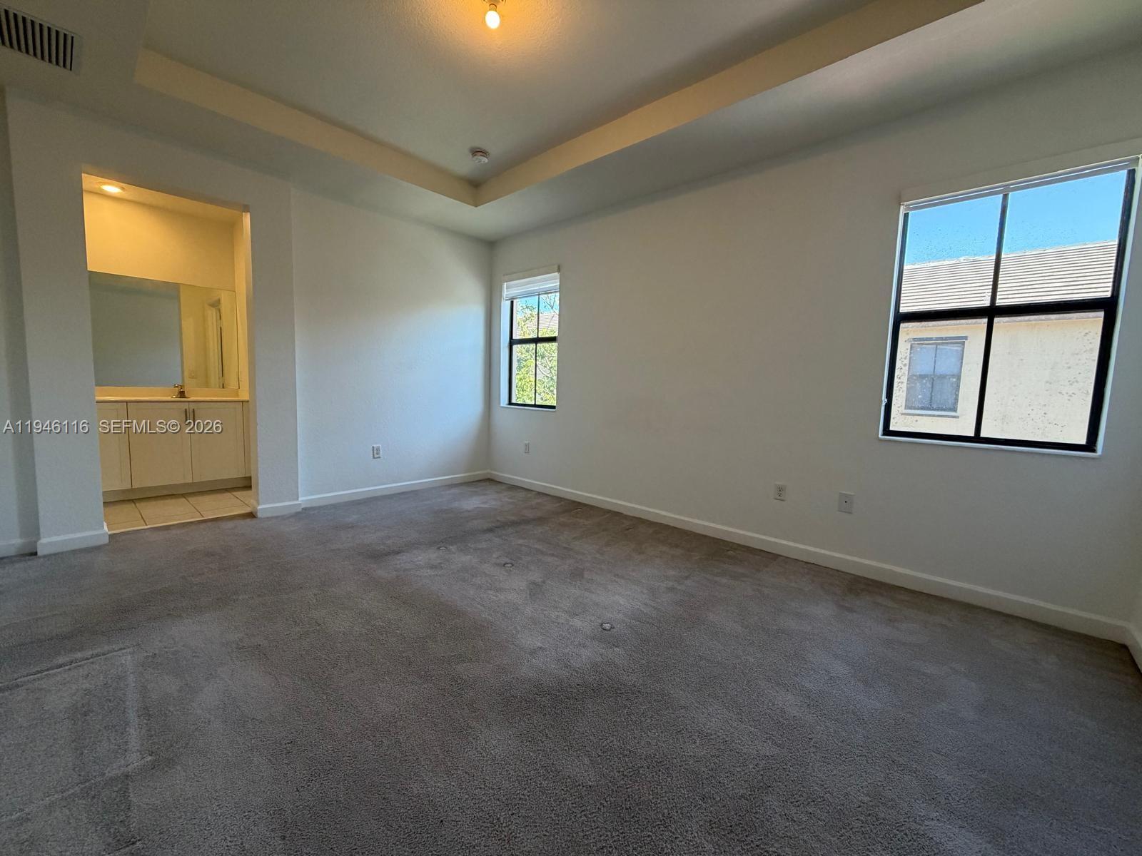 3326 West 112th Street Hialeah, FL 33018 - Photo 19 of 37 an empty room with windows and closet