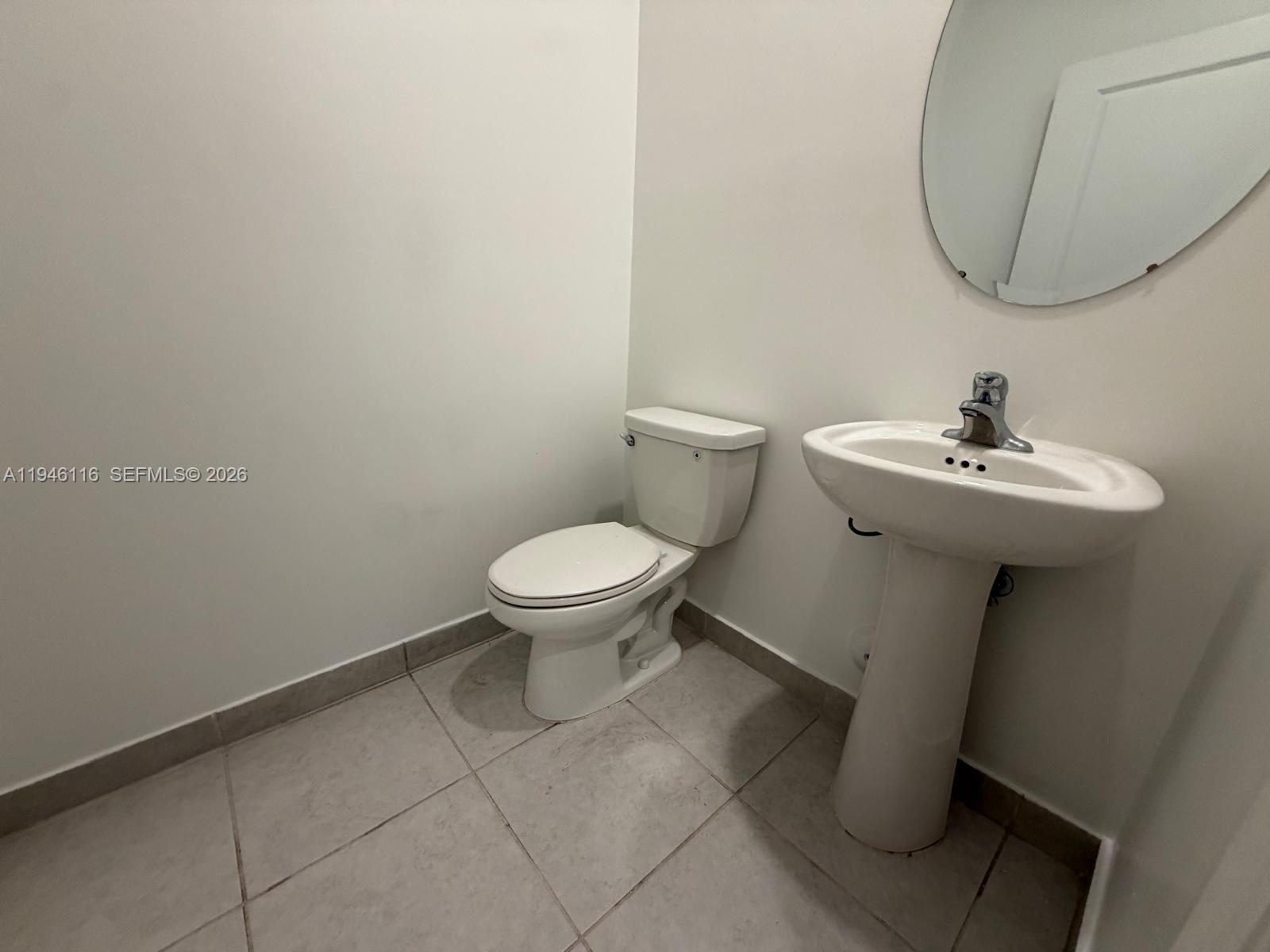 3326 West 112th Street Hialeah, FL 33018 - Photo 24 of 37 a bathroom with a sink and a mirror