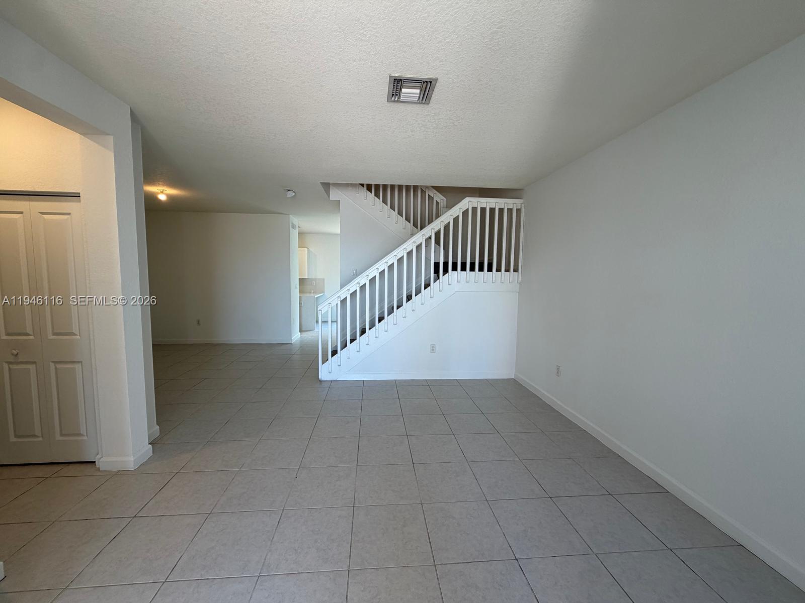 3326 West 112th Street Hialeah, FL 33018 - Photo 4 of 37 wooden floor in an empty room with a window