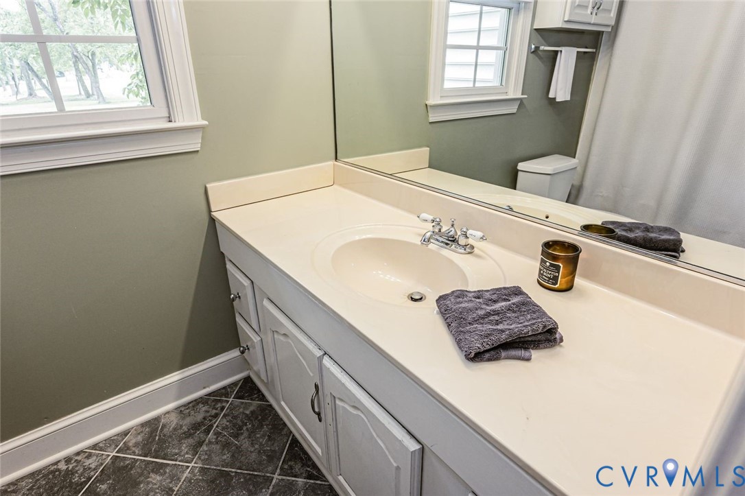 7300 Old Roxbury Road Quinton, VA 23141 - Photo 50 of 89 White vanity with an integrated sink and chrome fa