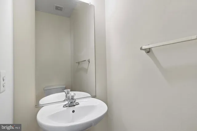 a bathroom with a sink a mirror and a shower