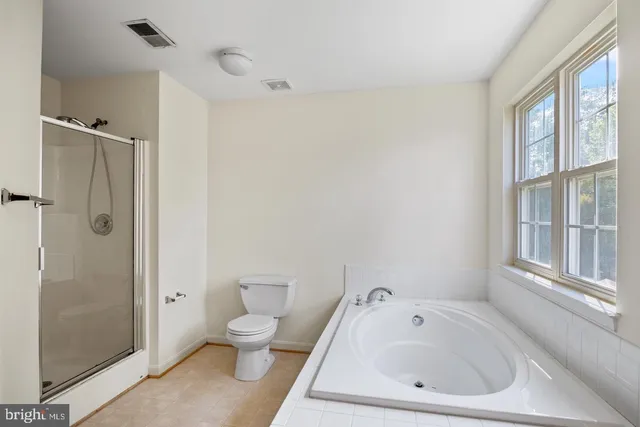 a white toilet sitting next to a bathroom sink