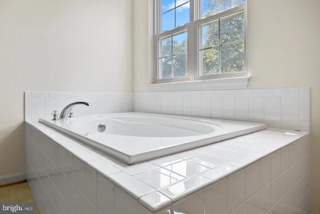 a bathroom with a tub and a window